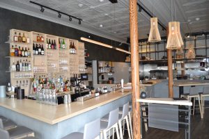 A large bar in the kitchen with many bottles of liquor